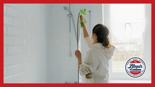 Woman cleaning shower.