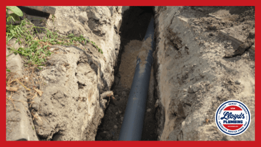 A sewer pipe sitting in a ground trench