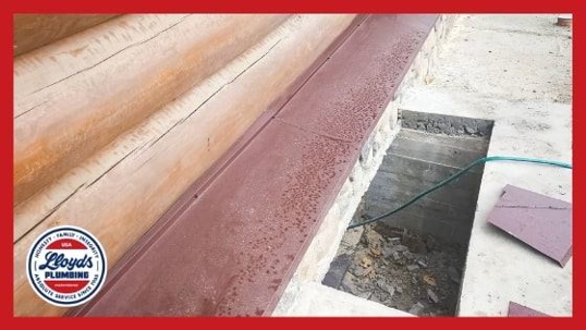 A home foundation with an opening and a wire extending underneath