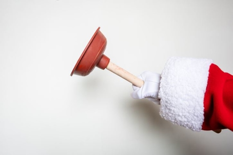 santa holding a plunger
